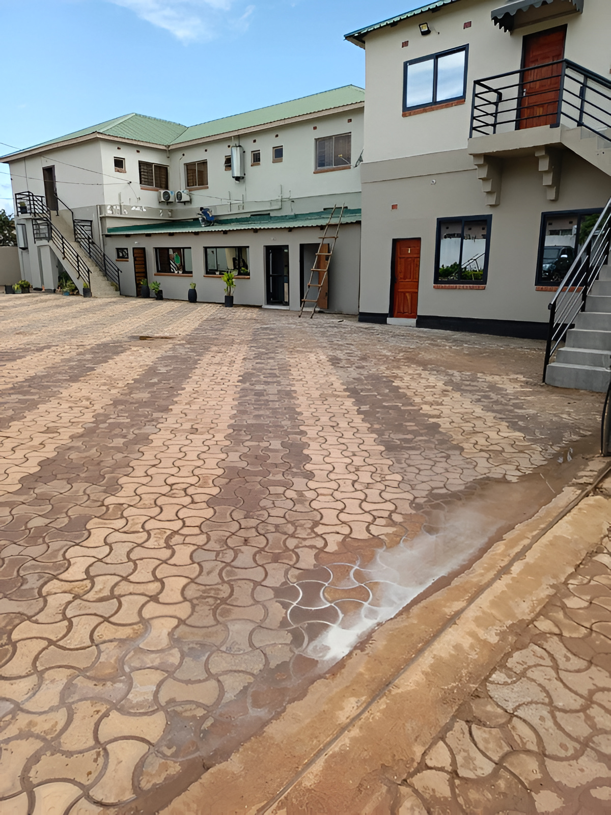 The lodge buildings and paved courtyard by day